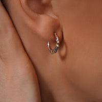 Load image into Gallery viewer, A Model Styling with 14k Gold Two Tone Puffed Bamboo Hoop Earrings 
