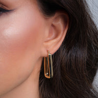 Load image into Gallery viewer, A model worn 14k Gold Chunky Rectangle-Shaped Hoop Earrings
