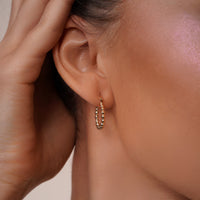 Load image into Gallery viewer, A Model Styling with 14k Gold Diamond-Cut Beaded Small Hoop Earrings
