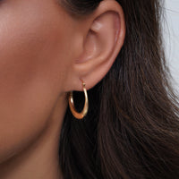 Load image into Gallery viewer, A Girl Worn a 14k Gold Textured Graduated Puff Hoop Earrings with Hinged Back
